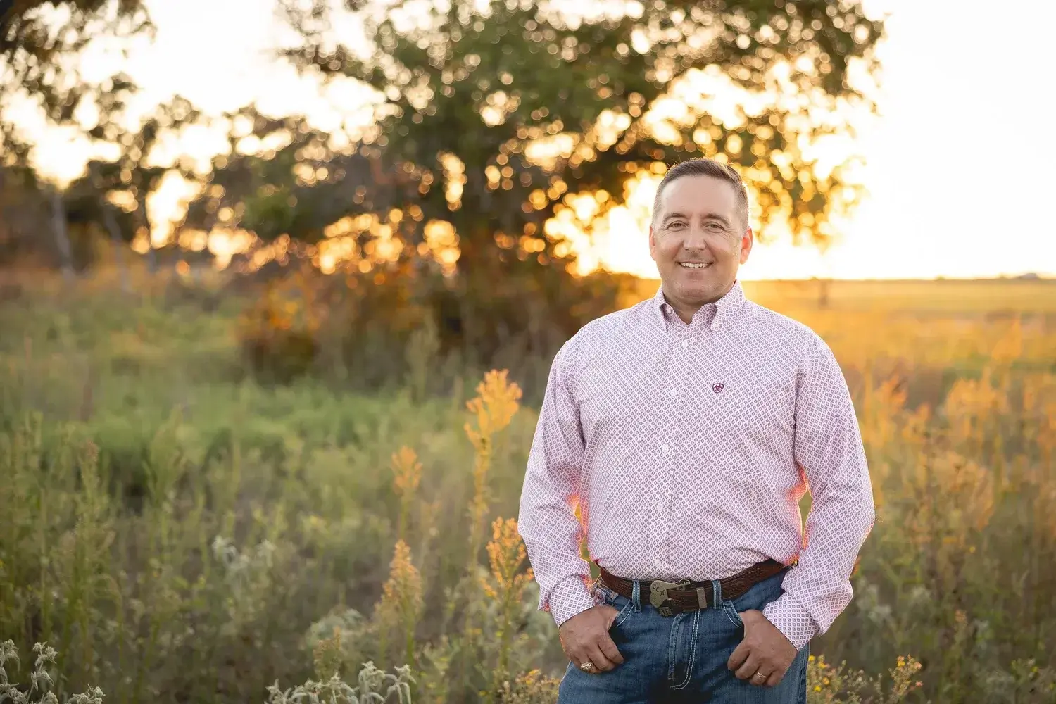 Jonathon Haralson of Empire Ag standing in a field at sunset