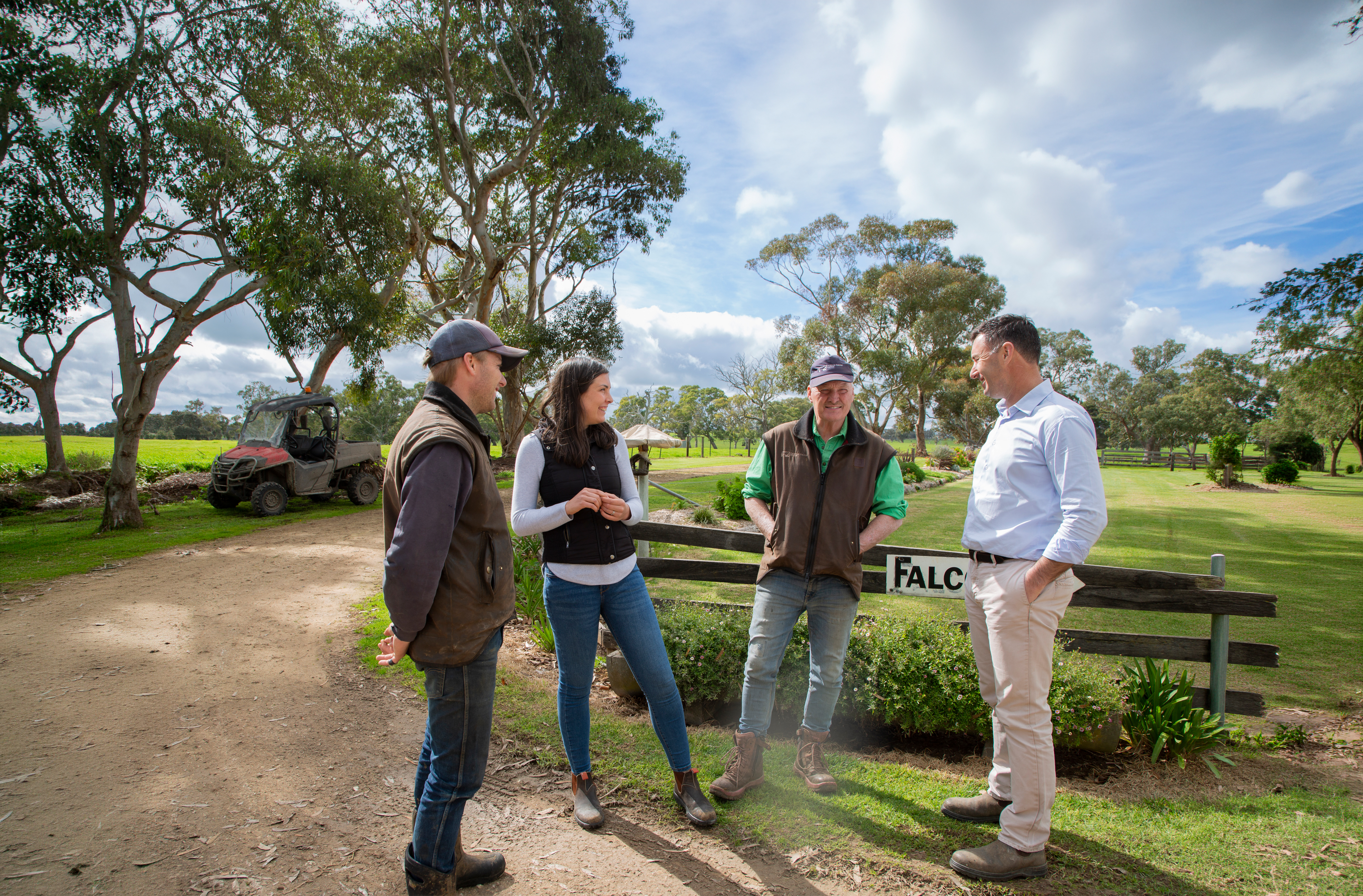 A farming family and their adviser talking together at the farm gate